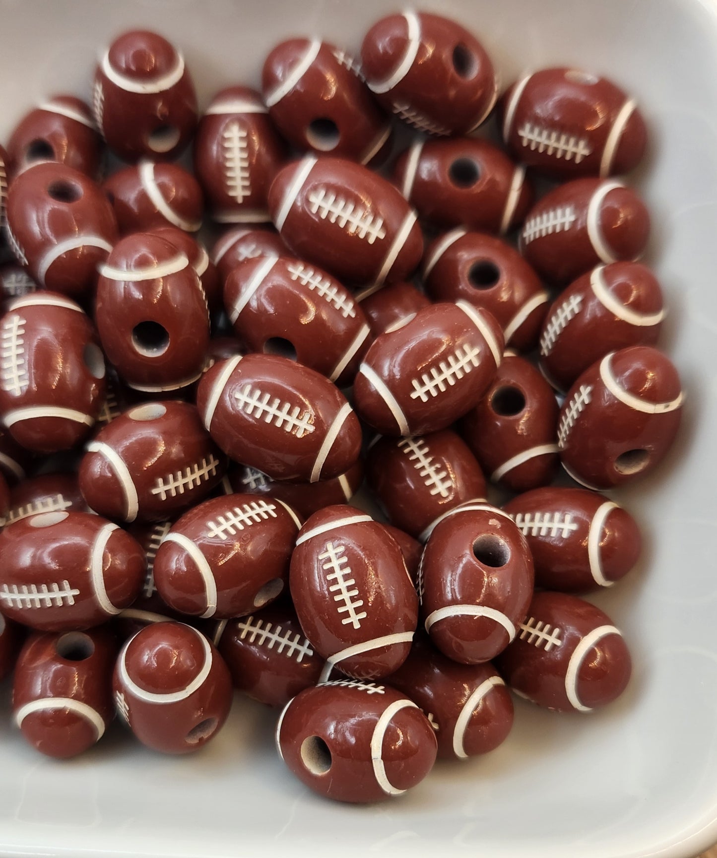 12 mm by 18 mm Acrylic Football beads. (*Individually sold* price for one bead)