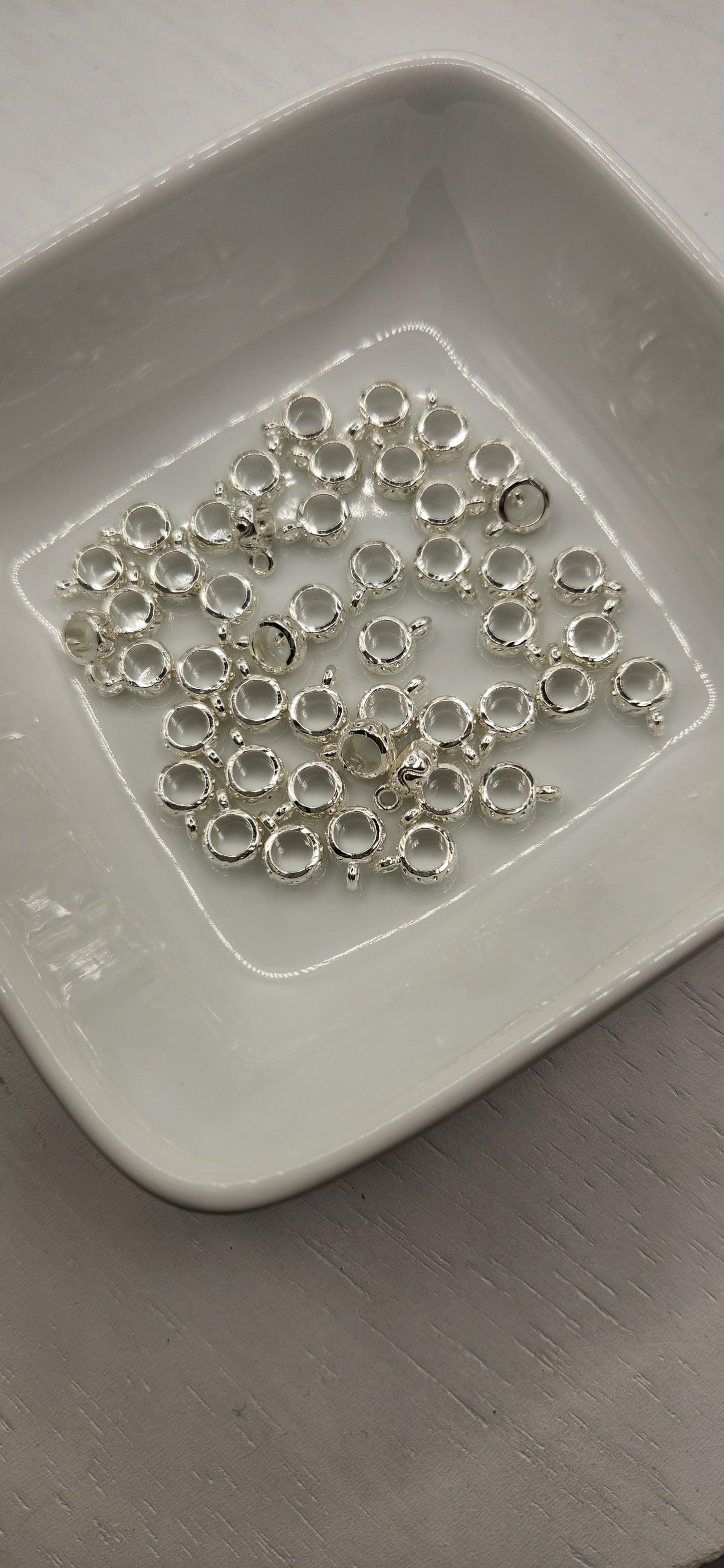 Bail spacers with charm *Individually sold